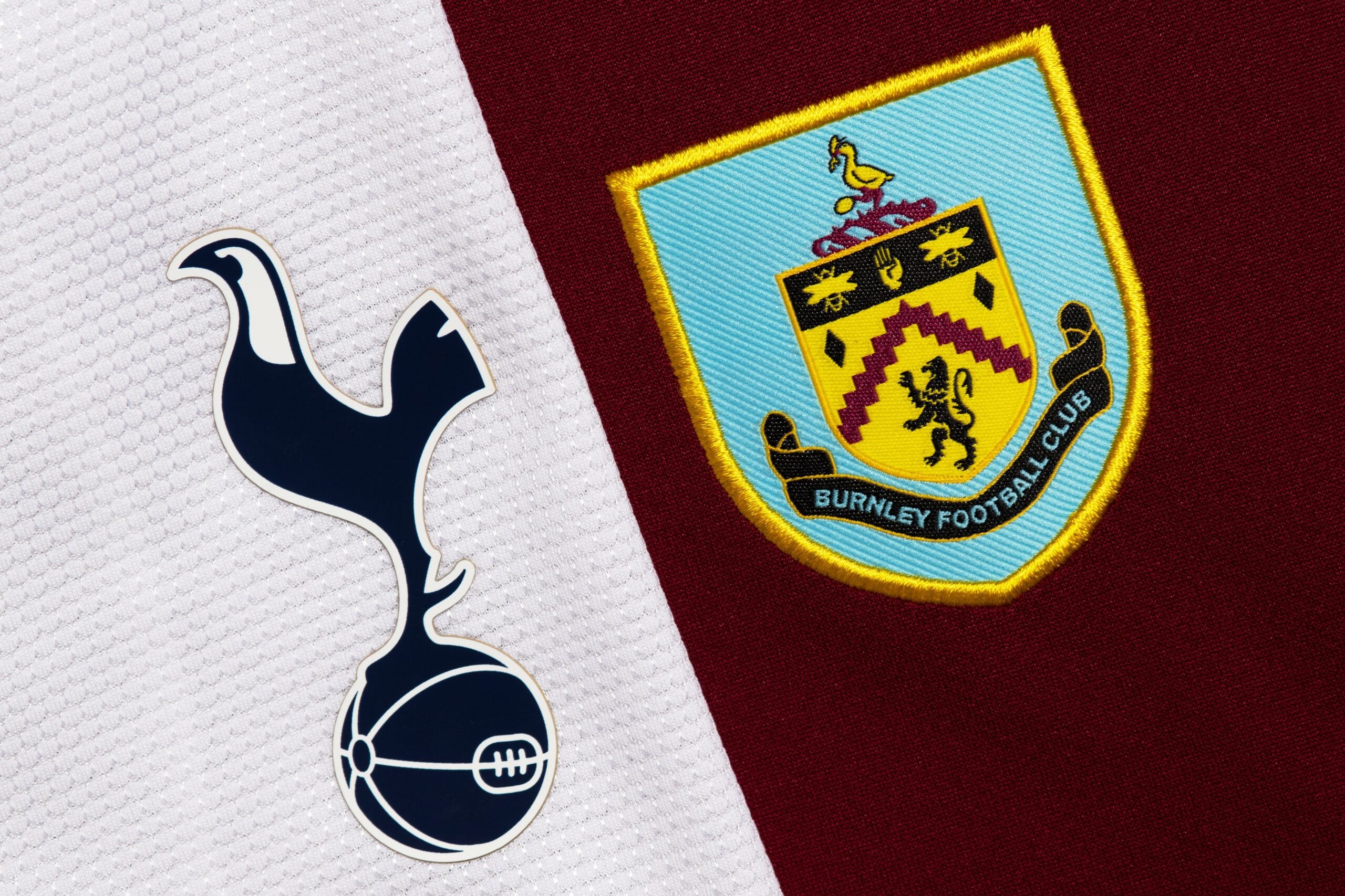 Close up of Burnley and Spurs club crest.